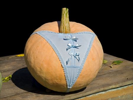 A close-up of the big yellow pumpkin in panties. Isolated on black.の写真素材