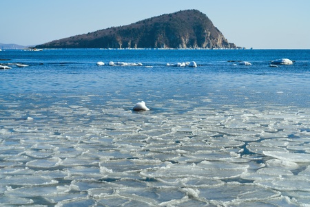 The small island in sea. Winter, stones and ice.の写真素材