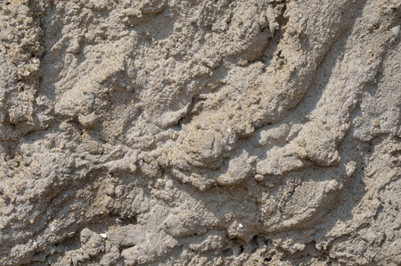 A close up of the very rough surface of concrete.