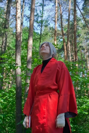 The young man cosplay a wizard in pine forest.の写真素材
