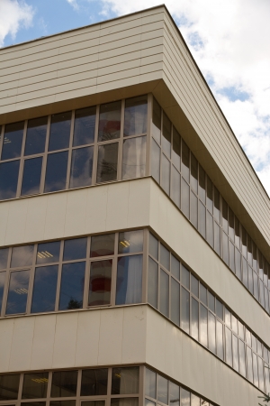 Curved exterior windows of a modern building  Curved exterior windows of a commercial office building reflecting a blue sky のeditorial素材