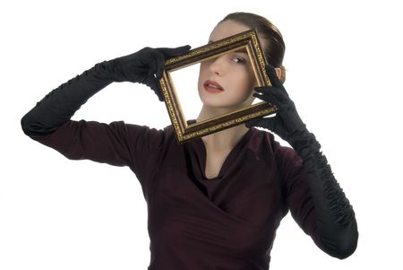 Young woman looking through picture frameの写真素材