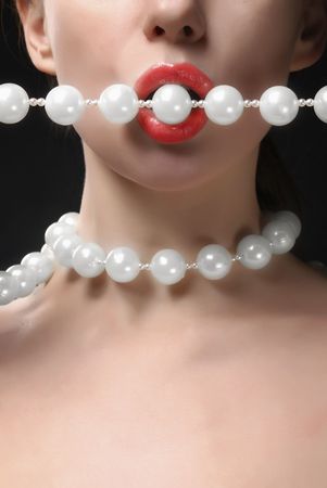 Woman open mouth with faux pearlsの写真素材
