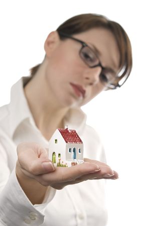 Image of business woman holding toy house on her palmの写真素材
