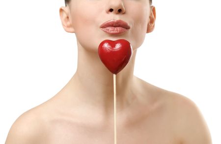 Beautiful woman holding red heart. Face closeup. Isolated on white backgroundの写真素材