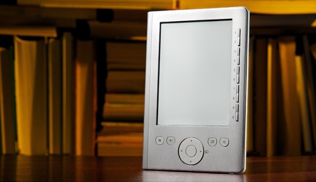 Electronic reader and an old books on the background
