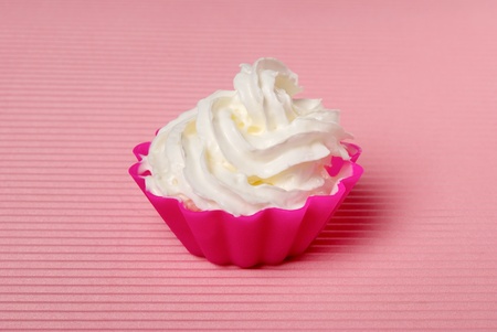 Portion of whipped cream over pink background. Shallow DOFの写真素材