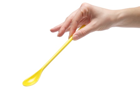 Hand holding an empty teaspoon, isolated on white backgroundの写真素材