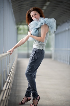 Young girl posing in a covered walkwayの写真素材