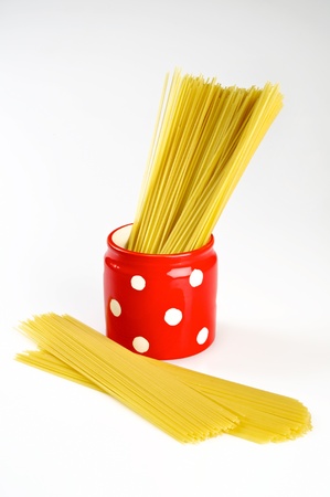 Spaghetti inside a red jar isolated on white backgroundの写真素材