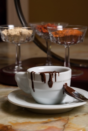 Cookies and coffe cup with chocolate flowingの写真素材