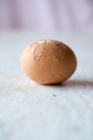 Close up of broken egg on white table