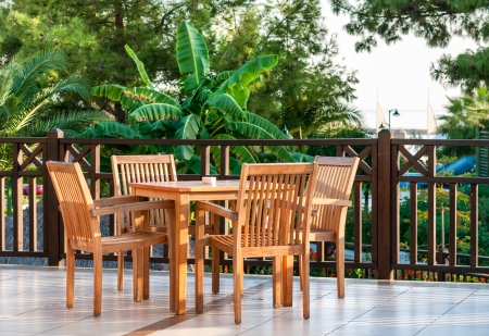 Table setting on a terraced lounge at a mediterranean resort hotel overlooking the seaの写真素材