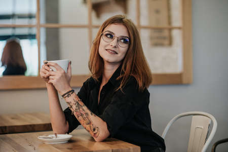 the young woman enjoys a coffee