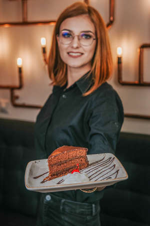 the waitress serves the chocolate cakeの写真素材