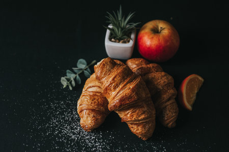 croissant and apple on blackの写真素材