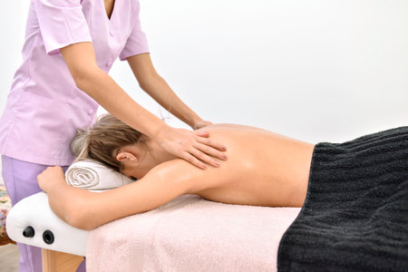woman receiving a back massageの写真素材