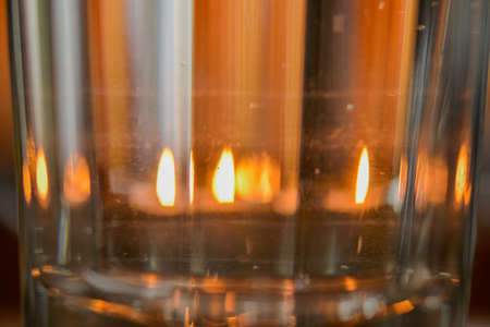 burning candle in the windowの写真素材