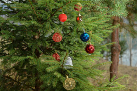Decorated Christmas tree with colorful baubles and ornamentsの写真素材