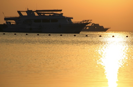 The yacht in the sea at sunriseの写真素材