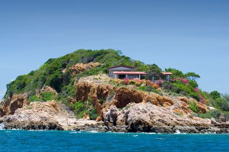 House on an island, close to waterの写真素材