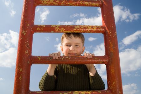 Boy having fun on the ladderの写真素材