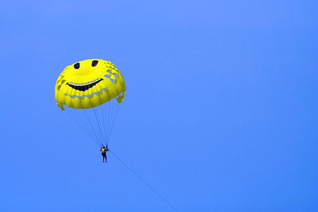 A man parasailing on the blue skyの写真素材
