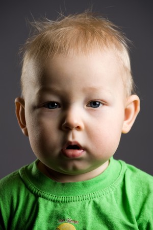 Portrait of the sleepy baby on a black backgroundの写真素材