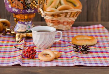 Vintage Russian samovar with a great cup of tea on a wooden backgroundの写真素材