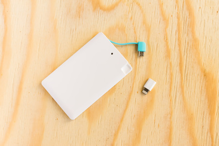power bank small mini, size on wooden backgroundの写真素材