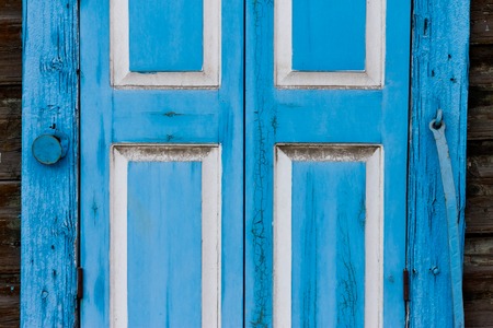 old wooden window shutters with peeling off paint rustyの写真素材