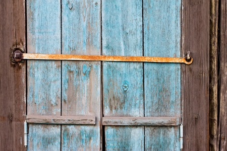old wooden window shutters with peeling off paint rustyの写真素材