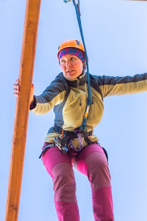 girl climbs into ropes course. Fearfully