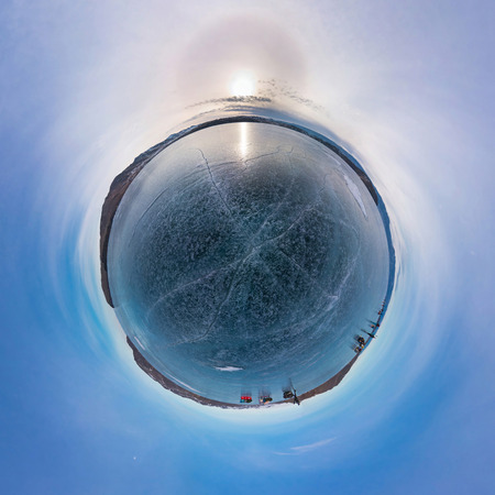 Tourists make the transition ice on Lake Baikal ice at sunset. Stereographic little planet panoramaの写真素材