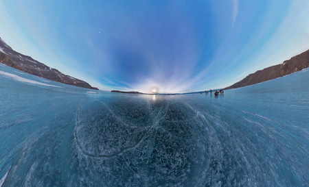 Tourists make the transition ice on Lake Baikal ice at sunset.の写真素材