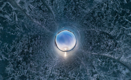Tourists make the transition ice on Lake Baikal ice at sunset. Stereographic little planet panoramaの写真素材