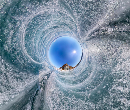 Spherical Panorama Shaman Rock or Cape Burhan on Olkhon Island in winter, surrounded by the blue ice of Lake Baikal with cracks.の写真素材