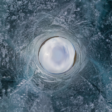 360 panorama blue ice of Lake Baikal covered with cracks, cloudy weather at sunsetの写真素材