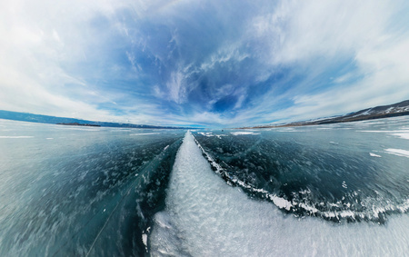 The road from the big white cracks on the ice of Lake Baikal. The polar panorama.の写真素材
