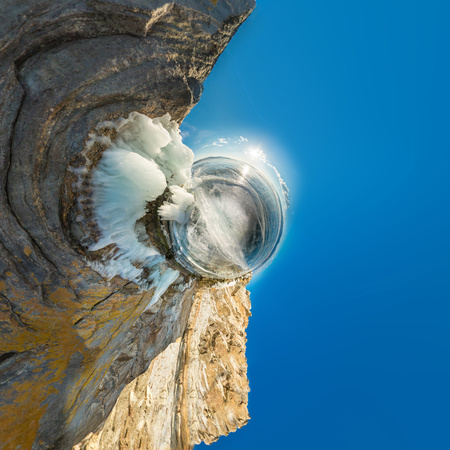 Rock on Olkhon covered with ice and icicles in Lake Baikal in winter. Polar little planet.の写真素材