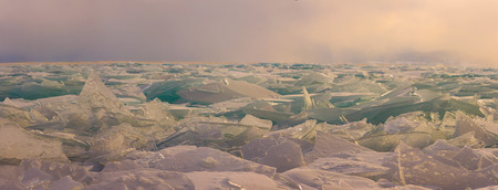 Transparent Baikal ice hummocks at sunset in the fog.の写真素材
