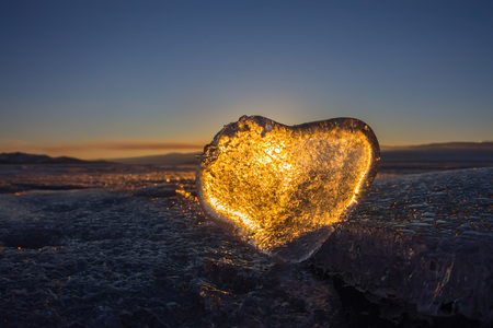 Icy heart in a crack in the light of sunset. lake Baikal.の写真素材