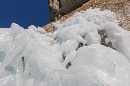 Icicles sokuy hanging over the head with a rock Olkhon Island on Lake Baikal.