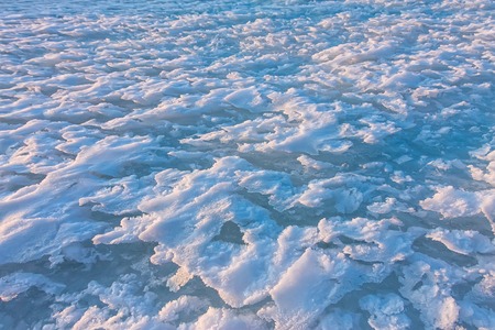 background snow waves at sunset by the wind.の写真素材