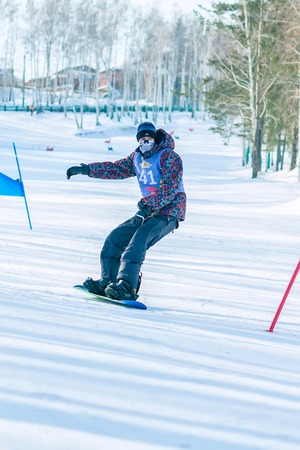 Irkutsk, Russia - February 12, 2017: Slalom competition snowboarding and skiing for adults and children in Irkutsk on the ski base in Akademgorodok Academy Cup in 2017のeditorial素材