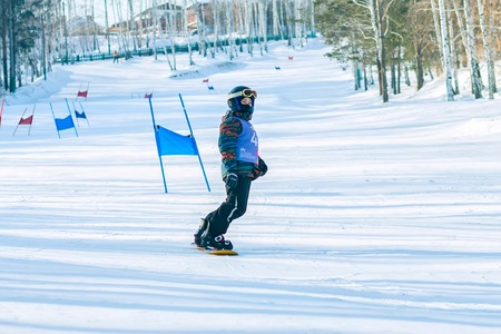 Irkutsk, Russia - February 12, 2017: Slalom competition snowboarding and skiing for adults and children in Irkutsk on the ski base in Akademgorodok Academy Cup in 2017のeditorial素材