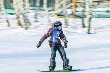 Irkutsk, Russia - February 12, 2017: Slalom competition snowboarding and skiing for adults and children in Irkutsk on the ski base in Akademgorodok Academy Cup in 2017のeditorial素材