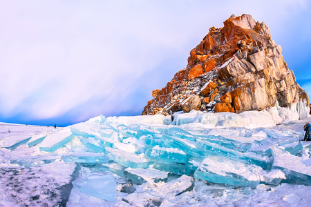 The ice of Lake Baikal at the rock Shamanka, illuminated by the setting sun.の写真素材