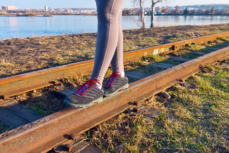 Cross-country trail running people at sunset. Runner couple exercising outside as part of healthy lifestyle.の写真素材