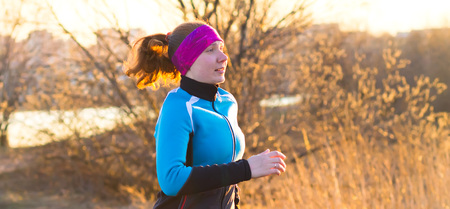 Cross-country trail running people at sunset. Runner couple exercising outside as part of healthy lifestyleの写真素材